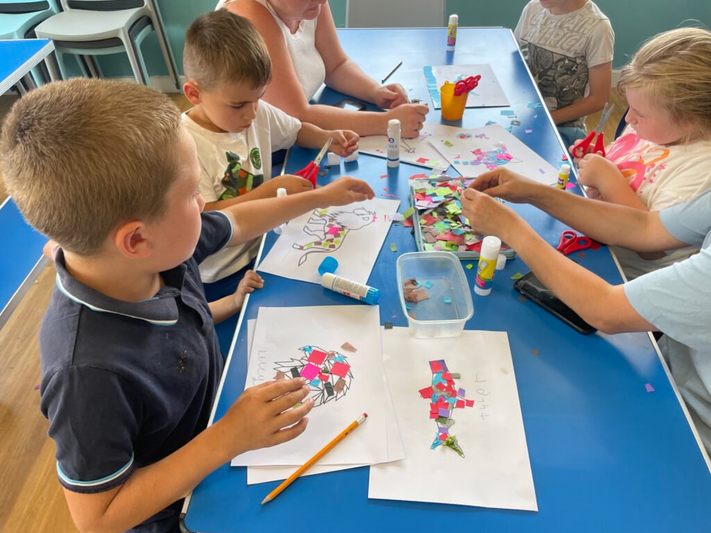 A group of children create collages of animals with Paul Broesmith as part of the Animates project