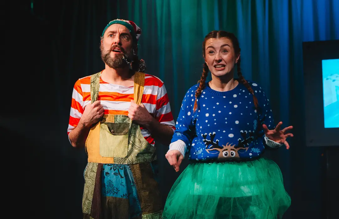 Two actors performing in a live production of Merry Elwin the Christmas Elf.